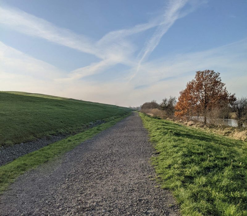 A beautiful cloudscape over a gravel walkway at daytime in Emden, Germany